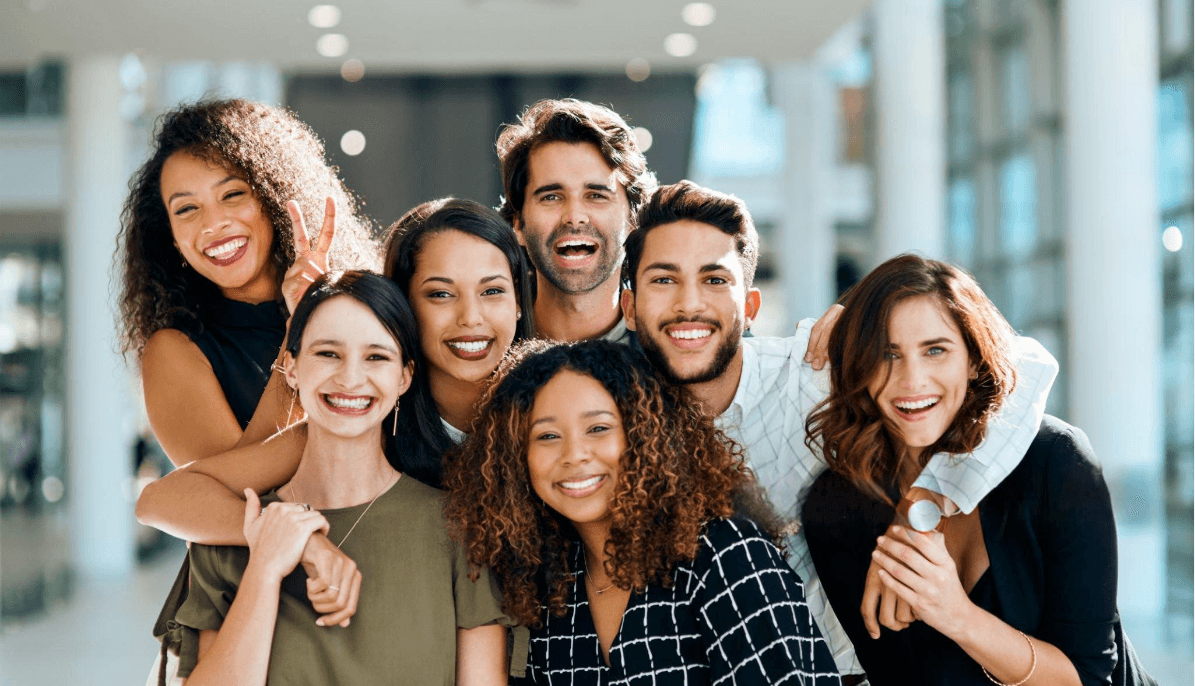A large, diverse group of smiling colleagues together