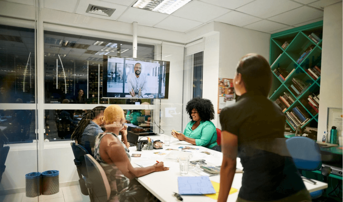 A team on a video call together in a meeting room